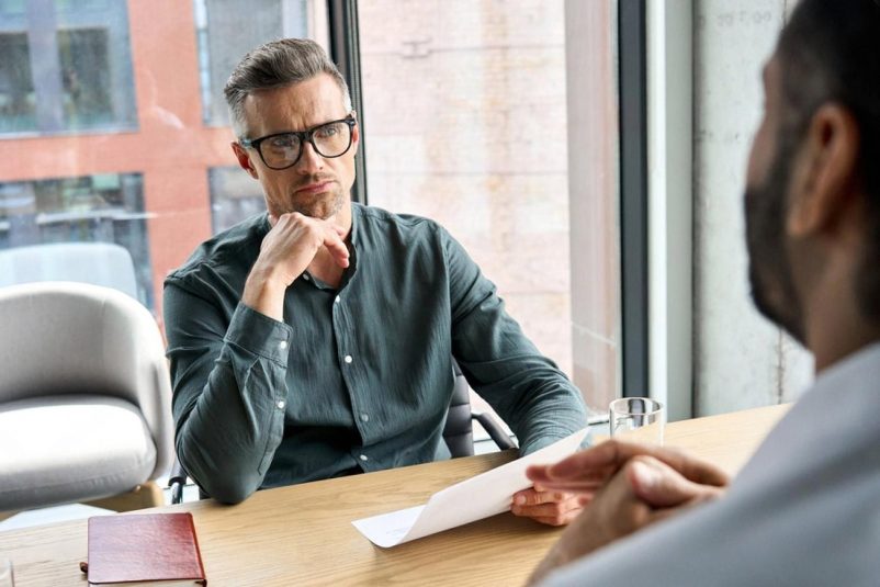 Hiring manager interviewing a candidate in a Dubai office